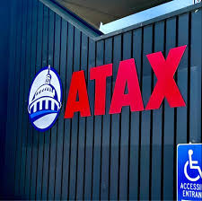 ATAX bilingual storefront with eagle signage — a brand presence that helps recruit bilingual preparers from the local community